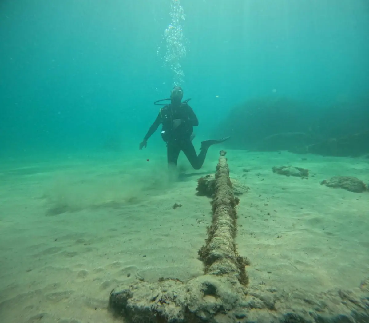 Diver next to an old anchor