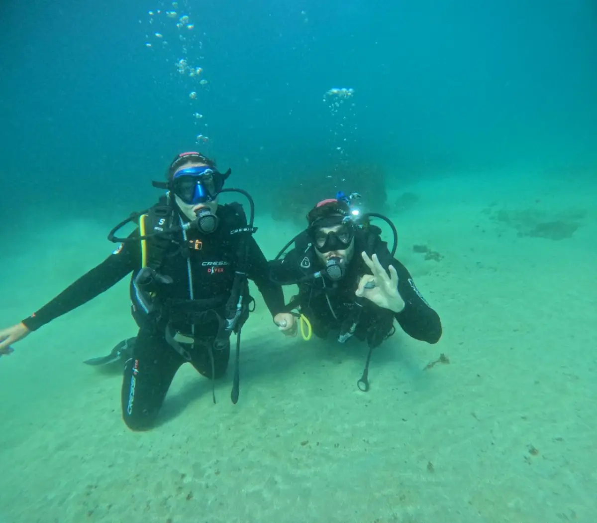 Two divers giving the OK sign
